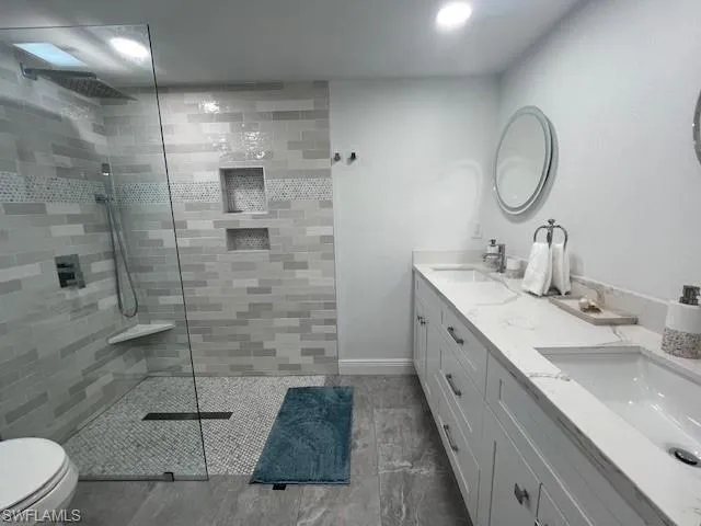 LARGE WALK-IN SHOWER W/RAINSHOWER HEAD.  THE LARGE VANITY OFFERS PLENTY OF STORAGE and DUAL SINKS.