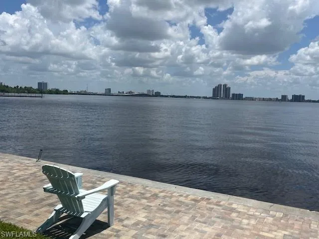 This pavered deck, situated along the community's riverfront, is a perfect place to sit and relax by day...  and by night enjoy the downtown Ft Myers Skyline
