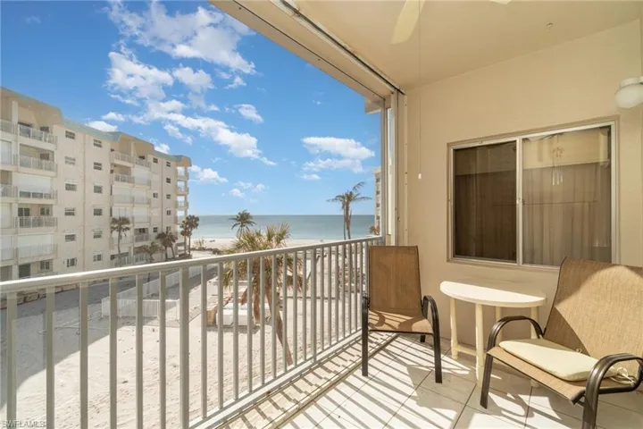 Balcony with a water view and a view of the beach