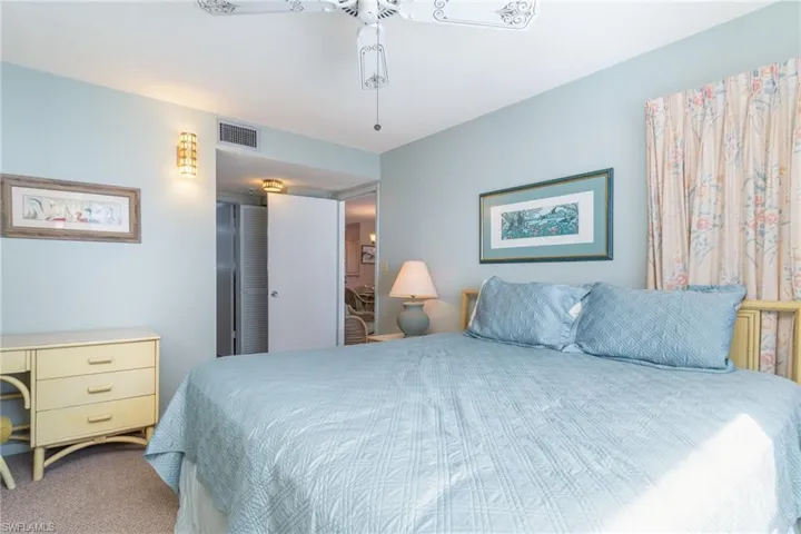 Carpeted bedroom featuring ceiling fan