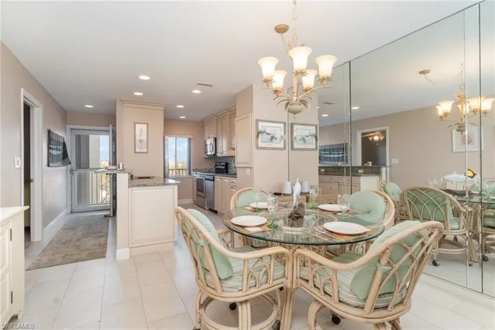 Dining area featuring light tile patterned floors and a notable chandelier