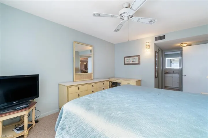 Carpeted bedroom featuring ceiling fan