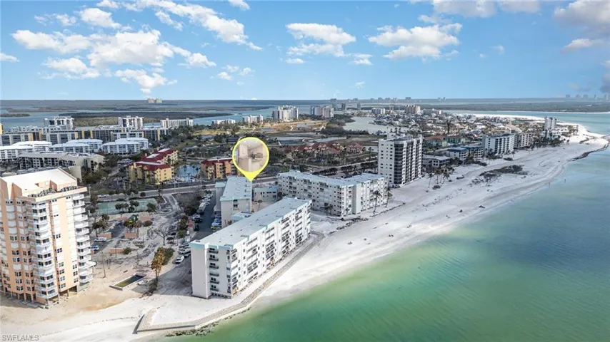 Drone / aerial view featuring a water view, a city view, and a beach view