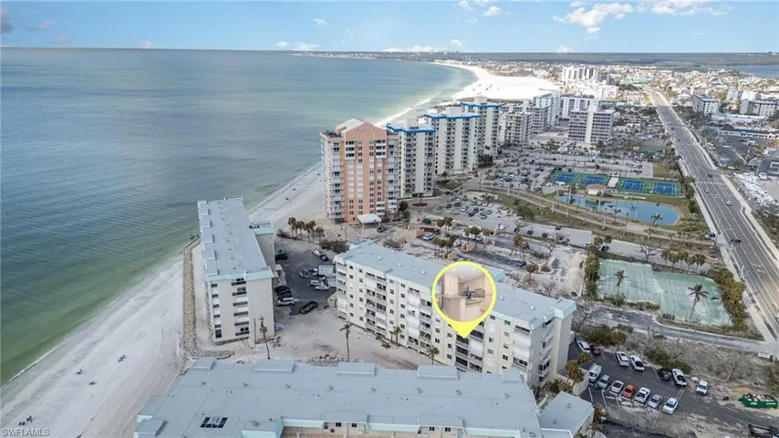 Drone / aerial view with a city view, a view of the beach, and a water view