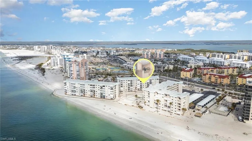 Drone / aerial view featuring a view of the beach, a view of city, and a water view