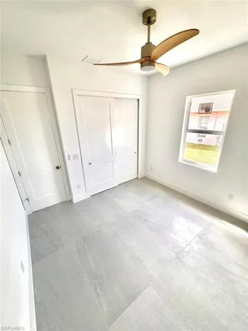 Unfurnished bedroom with a closet and ceiling fan