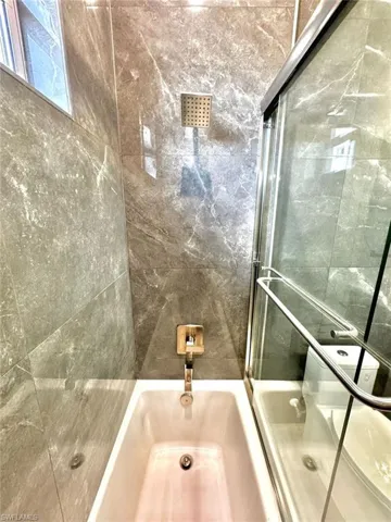 Bathroom with enclosed tub / shower combo