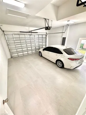Garage with a garage door opener and electric panel