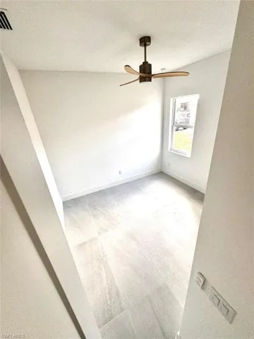 Unfurnished room with a textured ceiling and ceiling fan