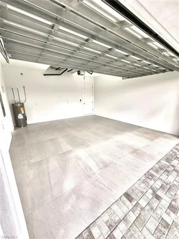 Garage with water heater and a garage door opener