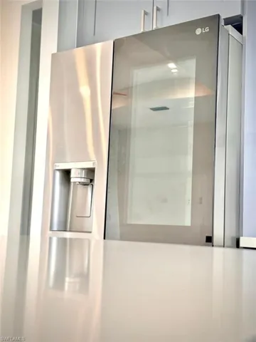 Interior details with stainless steel fridge with ice dispenser