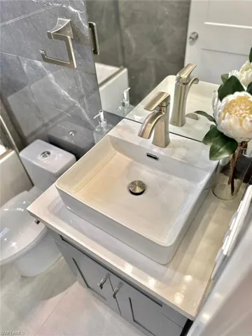 Bathroom with vanity, toilet, and tile patterned floors