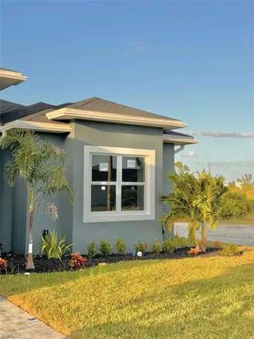 View of side of home with a lawn