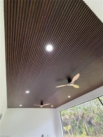 Detailed view of recessed lighting, ceiling fan, and a textured wall
