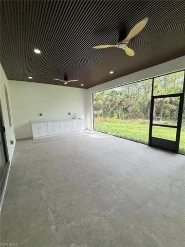 Spare room featuring concrete floors and a sink