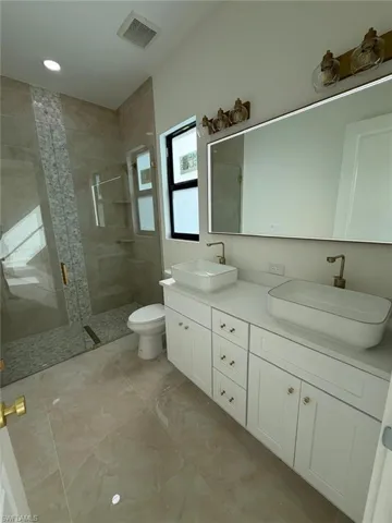 Bathroom with a shower stall and double vanity
