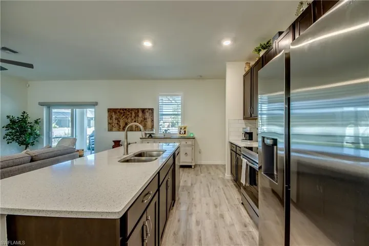 Beautiful white quartz countertops and dark cabinetry adorn this kitchen.