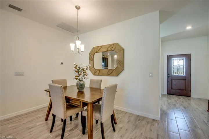 Front door, to the right of dining area, provides lots of light into home.