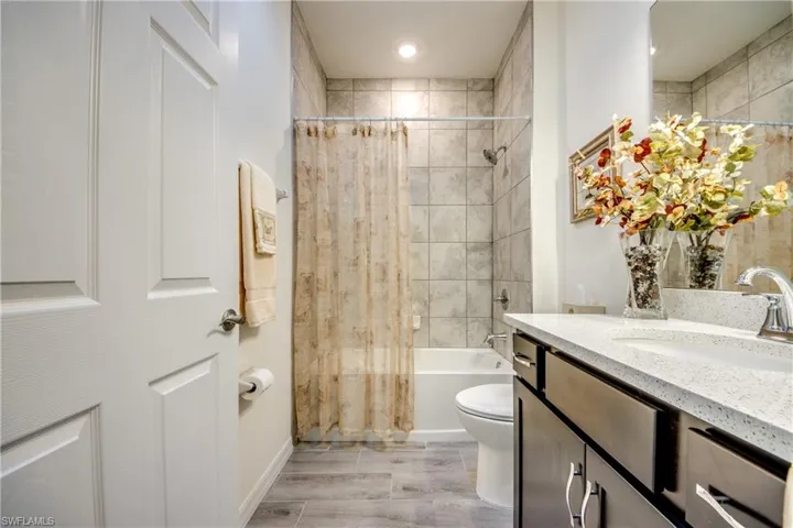 Secondary bathroom is between bedrooms 2 and 3. Combo tub/shower with tile surround and quartz counter. Skylight was installed to provide light without having to flip a switch. Nightlight on skylight is additional feature.