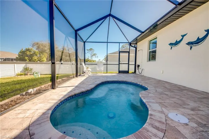 Spool (spa/pool) has a beautiful pebble finish and colorful tile. Steps lead down to a 3' depth and a generously-sized seat with 8 jets. Enjoy heated spa or unheated dipping pool. Outdoor shower is at far end of decking.