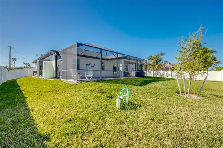 Backyard view from right rear corner. Equipment is hidden on right side of home. Well is in foreground.