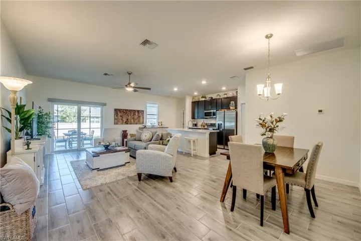 Dining, living, and kitchen areas make up the Great room. 9'4" ceiling heights and plank tile flooring throughout the home.