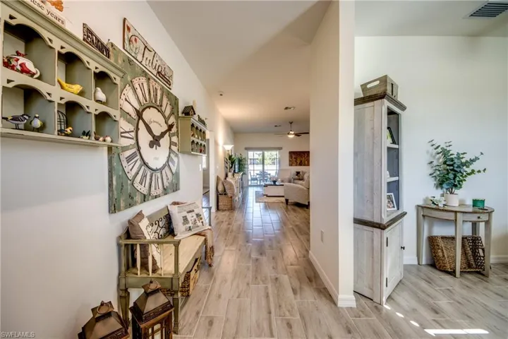 View from foyer reveals office on the right and impact resistant sliders straight ahead, through the Great room.