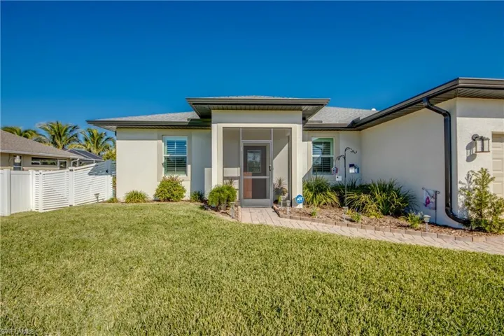 Screened front porch, paver walkway, gutters all around, impact glass windows/doors are just some of the upgrades in this CLEAN, beautiful home.