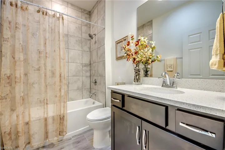 Secondary bathroom is between bedrooms 2 and 3. Combo tub/shower with tile surround and quartz counter. Skylight was installed to provide light without having to flip a switch. Nightlight on skylight is additional feature.