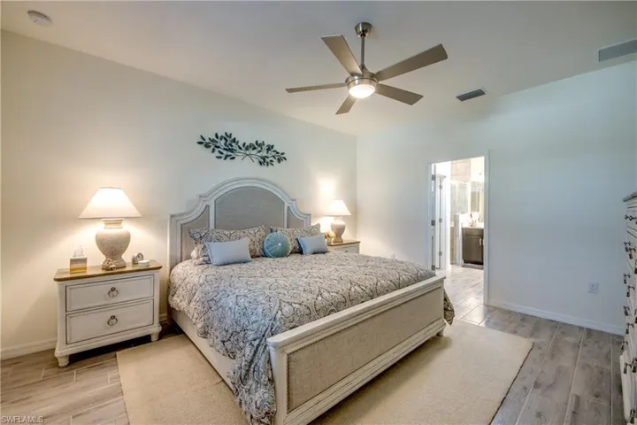 Plenty of room in the PRIMARY bedroom measuring over 15'x13'! Ensuite bathroom is through doorway shown. Every bedroom has a ceiling fan.