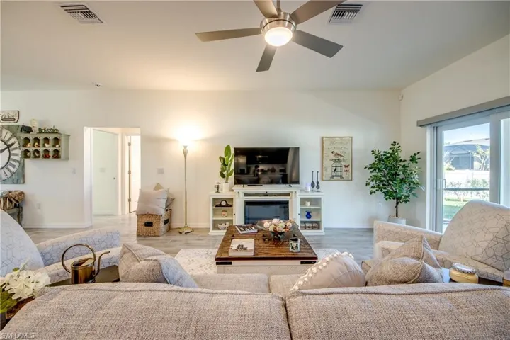 Great room is in center of home and has access to the screened lanai via the sliders on the right. Bedrooms 2 and 3 and guest bath are through the hallway shown.