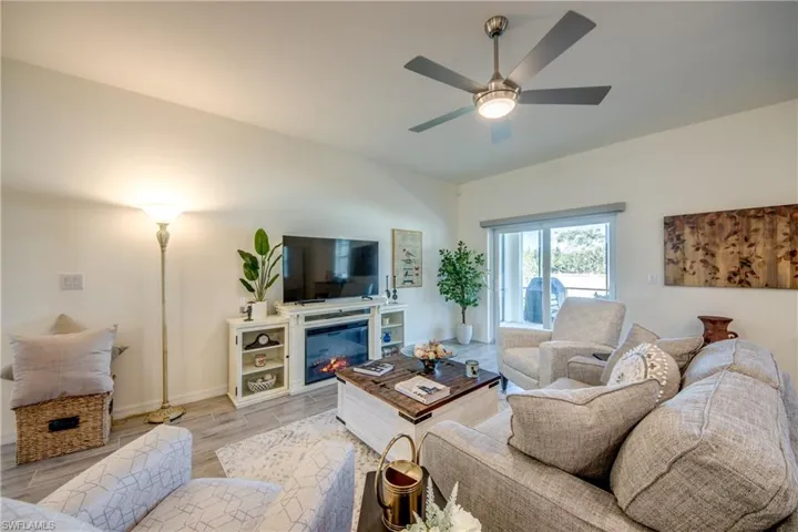 Great room is in center of home and has access to the screened lanai via the sliders on the right. 5 ceiling fans in the home and 1 on the lanai.