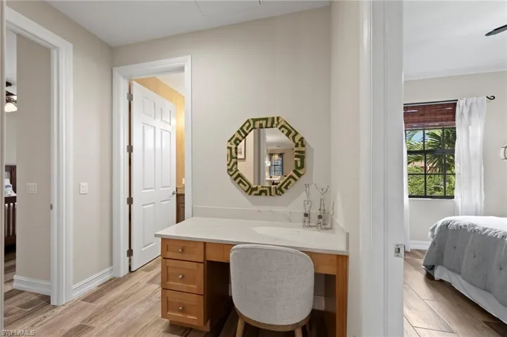 A workstation is conveniently located between the secondary bedrooms and can be closed off with a pocket door. NEW QUARTZ COUNTERS (2018), NEW TILE FLOOR (2018)