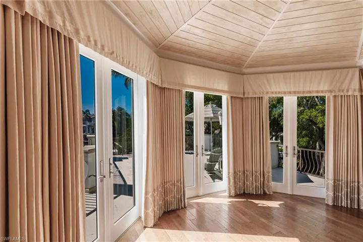 Entryway featuring hardwood / wood-style floors, wood ceiling, and french doors