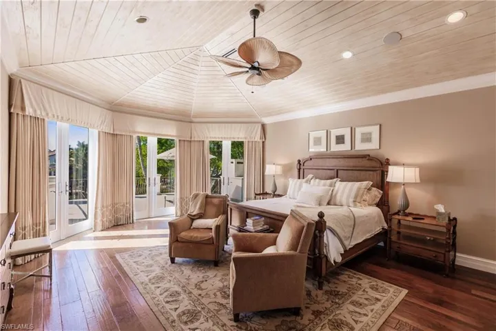 Bedroom featuring hardwood / wood-style flooring, access to exterior, ornamental molding, wooden ceiling, and french doors