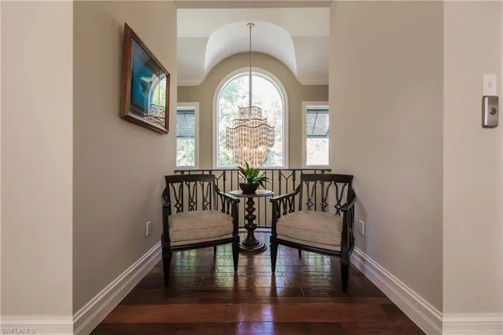 Sitting room with hardwood / wood-style flooring and an inviting chandelier
