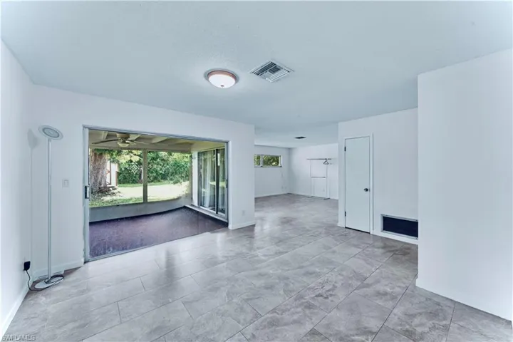 Spare room featuring a sunroom and a ceiling fan