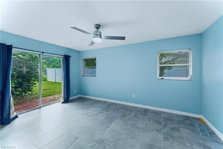 Unfurnished room featuring baseboards and ceiling fan