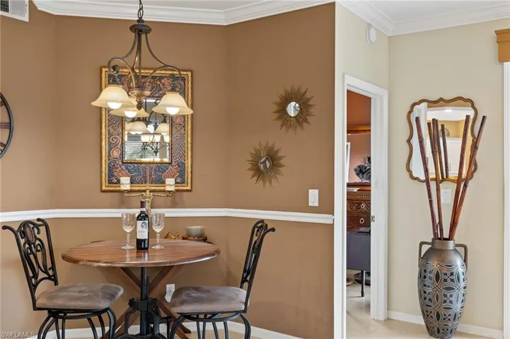Dining room featuring crown molding and an inviting chandelier