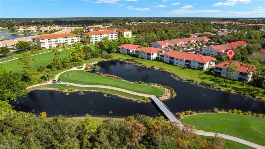 Birds eye view of property with a water view