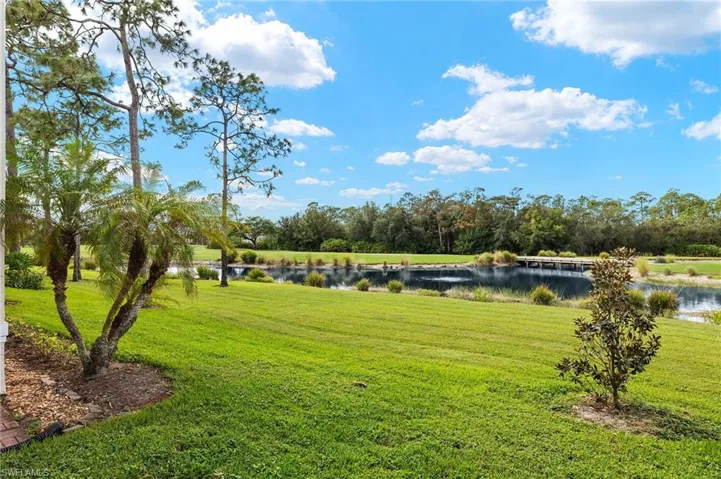 Surrounding community featuring a water view and a yard