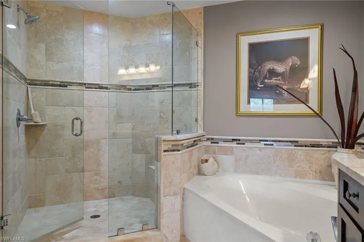 Bathroom featuring vanity and plus walk in shower