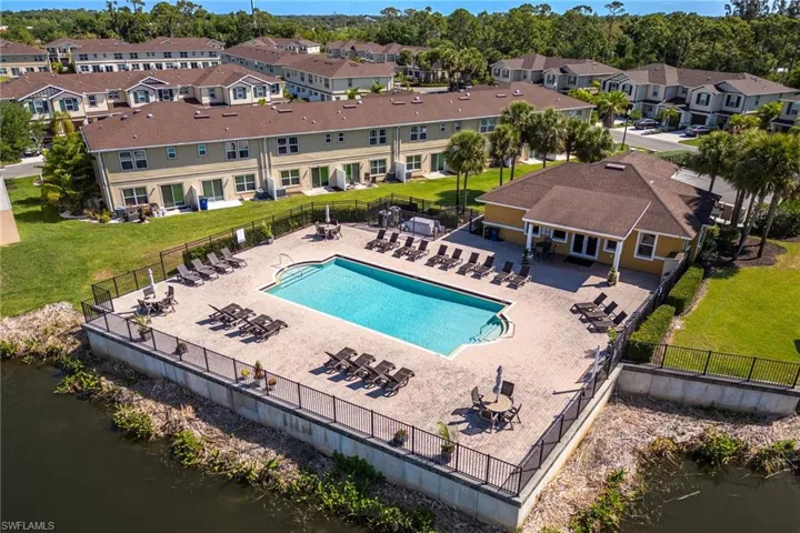Community pool with a patio and a water view