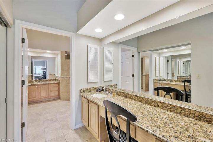 Large Granite Vanity Area with Sink I- Located in Front of Expansive Double Door Mirrored Walk In Closet