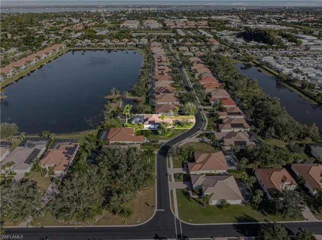 Aerial view of property's location featuring nearby suburban area and a nearby body of water