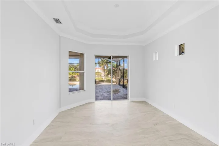 Spare room featuring ornamental molding and a raised ceiling