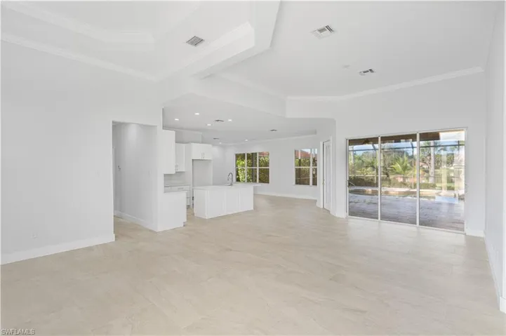 Unfurnished living room with crown molding