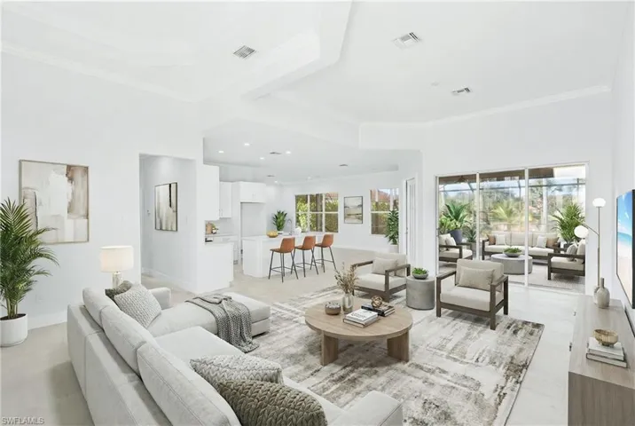 Living area featuring crown molding and baseboards