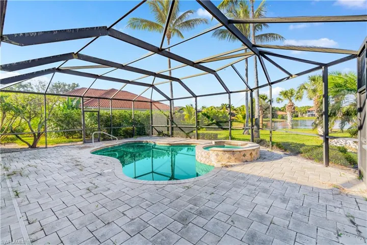 View of pool with a sunroom, a lanai, and a patio area