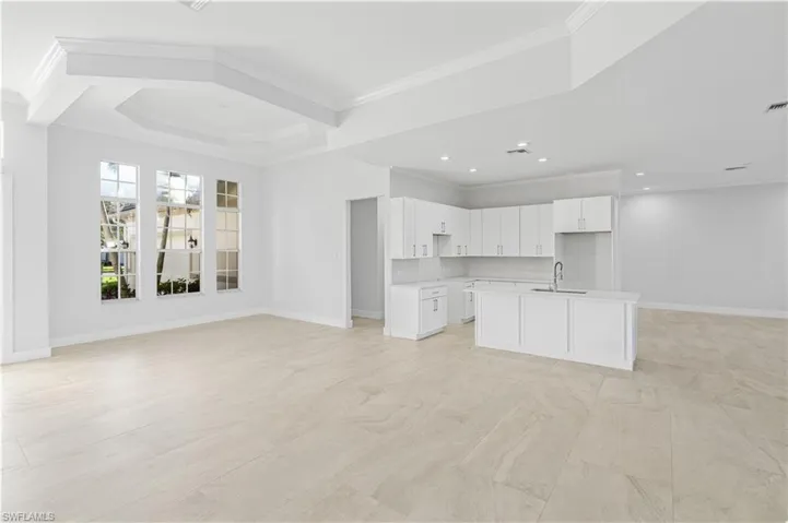 Unfurnished living room with crown molding